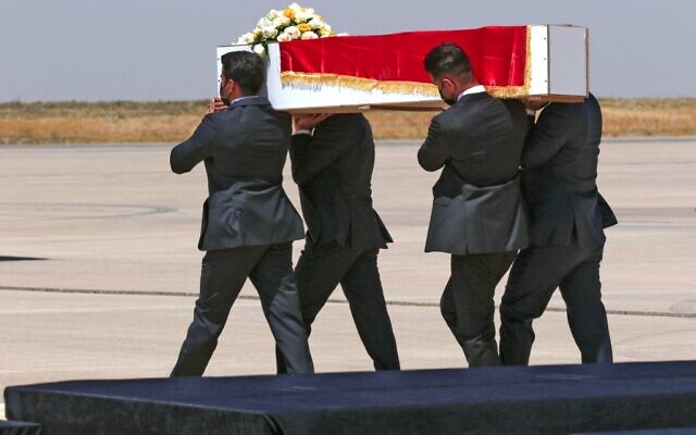 Pallbearers carry the casket of one of the victims killed a day earlier in a Kurdish hill village in an attack blamed on Turkey, before being flown to their cities from the airport in Arbil, the capital of Iraq's northern Kurdish autonomous region, on July 21, 2022 (SAFIN HAMED / AFP)