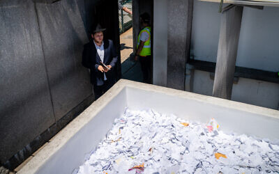 A man visits the gravesite of Rabbi Menachem Mendel Schneerson, the Chabad movement's spiritual leader, on the anniversary of his passing, New York City, July 3, 2022. (Luke Tress/Times of Israel)
