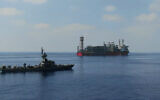 An Israeli Sa'ar Class 4.5 missile boat guards the Energean floating production, storage and offloading vessel at the Karish gas field, in footage published by the military on July 2, 2022. (Israel Defense Forces)