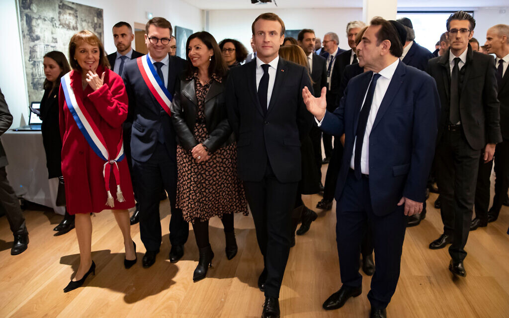 French President Emmanuel Macron, center, and Joel Mergui, right, the president of the Consistoire, visit the European Jewish Center during its official inauguration in Paris, October 29, 2019. (Ian Langsdon/ Pool/ AFP via Getty Images/ via JTA)
