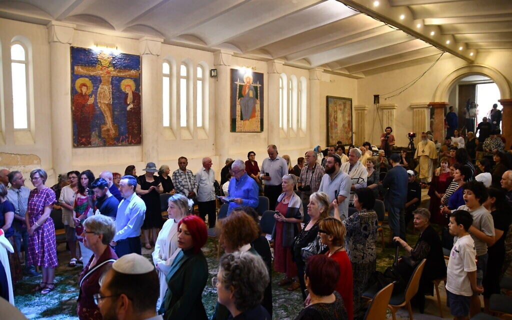 People gather at the inauguration of a Torah scroll at the Peace Cathedral in Tbilisi. (Nano Saralishvili/ via JTA)
