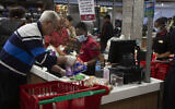 Shoppers at a Spar supermarket in Johannesburg, South Africa, March 24, 2020  (AP Photo/Denis Farrell)