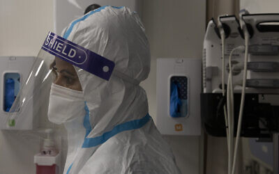 Illustrative image: A medical professional in protective equipment takes a short break, in the coronavirus ward of the Shaare Zedek Medical Center, in Jerusalem, Tuesday, Aug. 31, 2021. (AP Photo/Maya Alleruzzo)