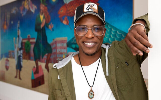 Nate Looney poses in front of a painting at the BAR Center at the Beach, June 16, 2022, in the Venice section of Los Angeles. (AP Photo/Mark J. Terrill)