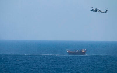Illustrative: A US Navy Seahawk helicopter flies over a stateless dhow later found to be carrying a hidden arms shipment in the Arabian Sea, May 6, 2021. (US Navy via AP) Illustrative: A US Navy Seahawk helicopter flies over a stateless dhow later found to be carrying a hidden arms shipment in the Arabian Sea, May 6, 2021. (US Navy via AP)