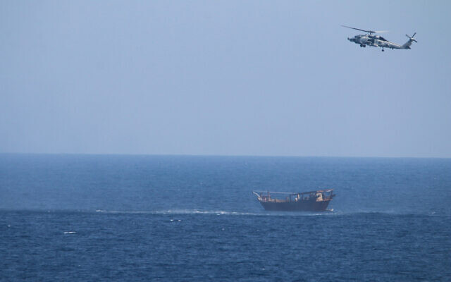 Illustrative: A US Navy Seahawk helicopter flies over a stateless dhow later found to be carrying a hidden arms shipment in the Arabian Sea, May 6, 2021. (US Navy via AP) Illustrative: A US Navy Seahawk helicopter flies over a stateless dhow later found to be carrying a hidden arms shipment in the Arabian Sea, May 6, 2021. (US Navy via AP)