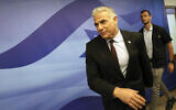 Prime Minister Yair Lapid arrives for the first cabinet meeting after lawmakers dissolved parliament, in Jerusalem, July 3, 2022. (Gil Cohen-Magen/Pool via AP)