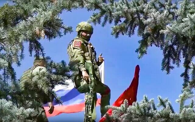 Russian soldiers set a Russian national flag and a replica of the Victory banner after capturing the eastern village of Bilohorivka which is now a territory under the Government of the Luhansk People's Republic control, eastern Ukraine, July 3, 2022. (Russian Defense Ministry Press Service via AP) Russian soldiers set a Russian national flag and a replica of the Victory banner after capturing the eastern village of Bilohorivka which is now a territory under the Government of the Luhansk People's Republic control, eastern Ukraine, July 3, 2022. (Russian Defense Ministry Press Service via AP)