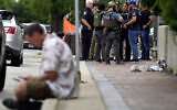 Law enforcement search after a mass shooting at the Highland Park Fourth of July parade in downtown Highland Park, a Chicago suburb on July 4, 2022. (AP Photo/Nam Y. Huh)
