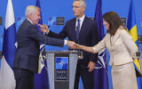 Finland's Foreign Minister Pekka Haavisto, left, Sweden's Foreign Minister Ann Linde, right, and NATO Secretary General Jens Stoltenberg attend a media conference after the signature of the NATO Accession Protocols for Finland and Sweden in the NATO headquarters in Brussels, Tuesday, July 5, 2022. (AP Photo/Olivier Matthys)