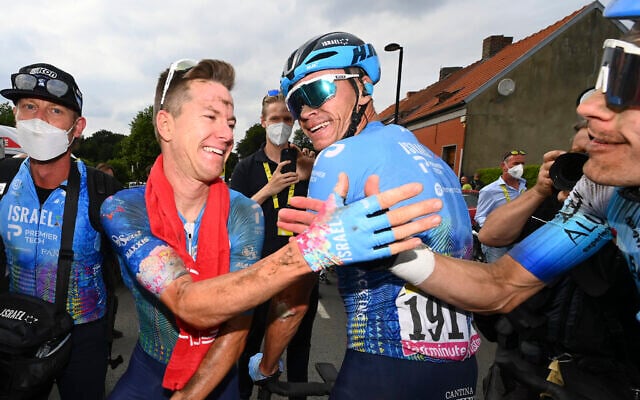 Stage winner Australia's Simon Clarke, second left, is congratulated by teammate Britain's Chris Froome, center, and another member of Israel Premier Tech after crossing the finish line of the fifth stage of the Tour de France cycling race in Arenberg Porte du Hainaut, France, July 6, 2022. (Tim De Waele/Pool Photo via AP) Stage winner Australia's Simon Clarke, second left, is congratulated by teammate Britain's Chris Froome, center, and another member of Israel Premier Tech after crossing the finish line of the fifth stage of the Tour de France cycling race in Arenberg Porte du Hainaut, France, July 6, 2022. (Tim De Waele/Pool Photo via AP)