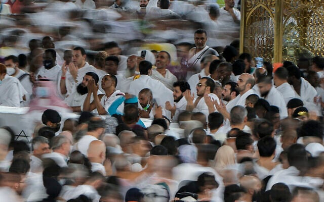In this photo taken with low shutter speed, Muslim pilgrims pray as others circumambulate around the Kaaba, the cubic building at the Grand Mosque, in Mecca, Saudi Arabia, July 6, 2022. (Amr Nabil/AP) In this photo taken with low shutter speed, Muslim pilgrims pray as others circumambulate around the Kaaba, the cubic building at the Grand Mosque, in Mecca, Saudi Arabia, July 6, 2022. (Amr Nabil/AP)