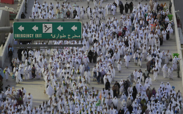 In this photo take by slow shutter, Muslim pilgrims walk to cast stones at a pillar in the symbolic stoning of the devil, during the last rite of the annual hajj, and the first day of Eid al-Adha, in Mina near the city of Mecca, Saudi Arabia, July 9, 2022. (AP Photo/Amr Nabil) In this photo take by slow shutter, Muslim pilgrims walk to cast stones at a pillar in the symbolic stoning of the devil, during the last rite of the annual hajj, and the first day of Eid al-Adha, in Mina near the city of Mecca, Saudi Arabia, July 9, 2022. (AP Photo/Amr Nabil)