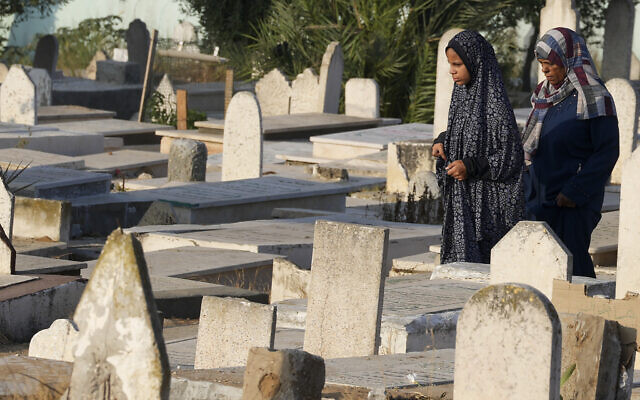Palestinians visit their relatives' graves at Gaza cemetery on the first day of Eid al-Adha in Gaza City, July 9, 2022. (AP Photo/Adel Hana) Palestinians visit their relatives' graves at Gaza cemetery on the first day of Eid al-Adha in Gaza City, July 9, 2022. (AP Photo/Adel Hana)