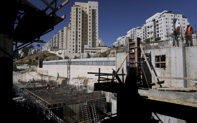 Palestinian laborers work at a construction site in a new housing project in Har Homa in East Jerusalem, July 6, 2022. (AP Photo/Mahmoud Illean) Palestinian laborers work at a construction site in a new housing project in Har Homa in East Jerusalem, July 6, 2022. (AP Photo/Mahmoud Illean)