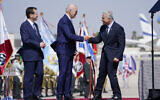 US President Joe Biden, center, fist bumps Prime Minister Yair Lapid, right, as they participate in an arrival ceremony with President Isaac Herzog, left, after Biden arrived at Ben Gurion Airport, July 13, 2022. (Evan Vucci/AP)