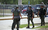 Law enforcement personnel stand outside Robb Elementary School following a shooting in Uvalde, Texas, May 24, 2022. (AP Photo/Dario Lopez-Mills, File)