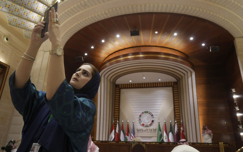 A reporter poses for a selfie after the end of Security and Development Summit in Jeddah, Saudi Arabia, Saturday, July 16, 2022. (AP Photo/Amr Nabil)