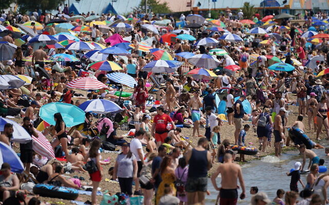People relax on the beach at Southend-on-Sea on the Thames Estuary in Essex, Britain, July 17, 2022. (Yui Mok/PA via AP) People relax on the beach at Southend-on-Sea on the Thames Estuary in Essex, Britain, July 17, 2022. (Yui Mok/PA via AP)