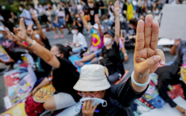 Pro-democracy activists flash a three-fingered symbol or resistance during a rally in Bangkok, Thailand, on March 24, 2021. (Sakchai Lalit/AP) Pro-democracy activists flash a three-fingered symbol or resistance during a rally in Bangkok, Thailand, on March 24, 2021. (Sakchai Lalit/AP)