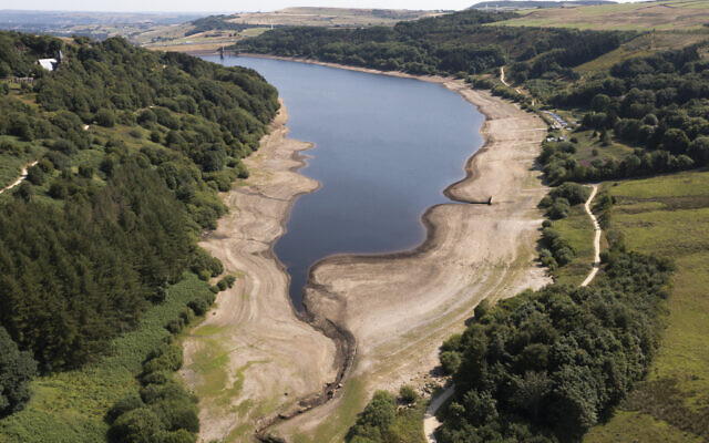 Low water levels are seen at Scammonden Reservoir in West Yorkshire as reservoir levels dip dangerously low amid record high temperatures in the UK in Oldham, England, Monday, July 18, 2022. (AP Photo/Jon Super)