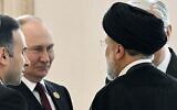 Russian President Vladimir Putin, left, speaks to Iran's President Ebrahim Raisi, back to a camera, on the sideline of the summit of Caspian Sea littoral states in Ashgabat, Turkmenistan, on June 29, 2022. (Grigory Sysoyev, Sputnik, Kremlin Pool Photo via AP, File)