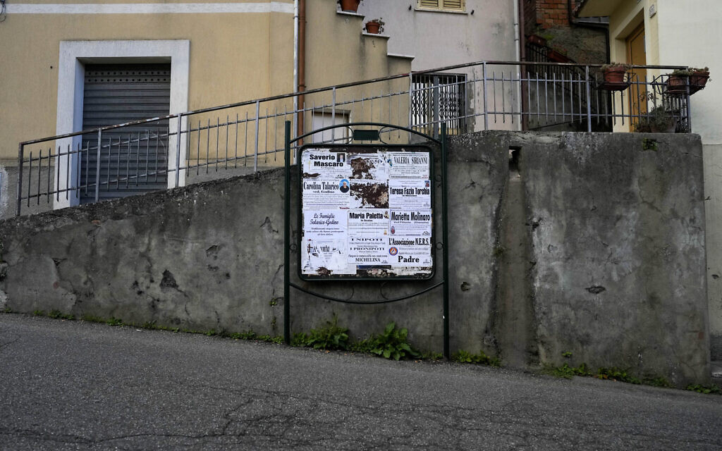 Obituaries are seen on a street of Serrastretta, southern Italy,  July 8, 2022 (AP Photo/Andrew Medichini)