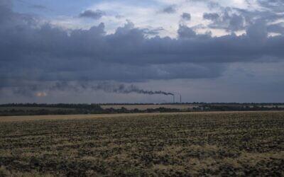 Grain fields backdropped by a power plant in Donetsk region, eastern Ukraine, Friday, July 22, 2022. (AP/Nariman El-Mofty)