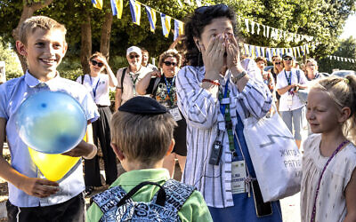 Elina Tabachenko, a schoolteacher from Ukraine, is reunited with her students in Nes Harim, Israel, on Monday, July 25, 2022. (AP/Tsafrir Abayov)