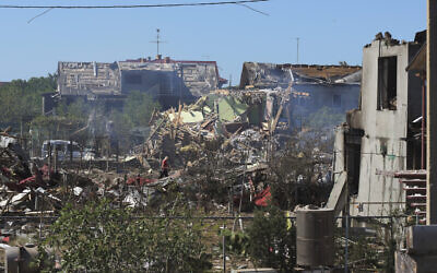 A woman walks among apartment buildings destroyed by Russian shelling on the outskirts of Odesa, Ukraine, July 26, 2022. (Michael Shtekel/AP)