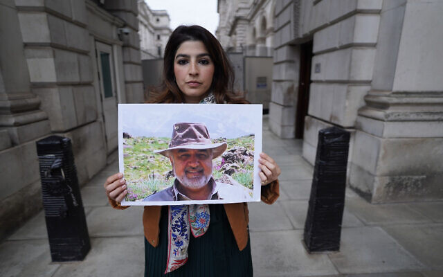 Roxanne Tahbaz holds a picture of her father Morad Tahbaz who is jailed in Iran, during a protest outside the Foreign, Commonwealth and Development Office in London, April 13, 2022. (Stefan Rousseau/PA via AP, File) Roxanne Tahbaz holds a picture of her father Morad Tahbaz who is jailed in Iran, during a protest outside the Foreign, Commonwealth and Development Office in London, April 13, 2022. (Stefan Rousseau/PA via AP, File)