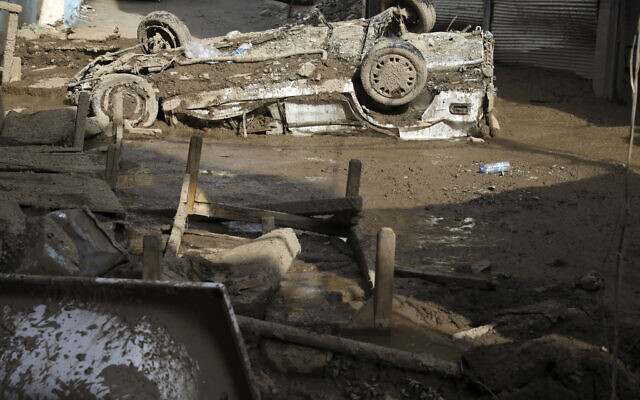 A damaged car is stuck in the mud upside down after flash floods in the northwestern part of Tehran, Iran, Thursday, July 28, 2022. (AP/Vahid Salemi) A damaged car is stuck in the mud upside down after flash floods in the northwestern part of Tehran, Iran, Thursday, July 28, 2022. (AP/Vahid Salemi)