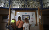 Ukrainian refugee children look at the drawings at the Lauder Morasha Jewish school in Warsaw, Poland, Thursday, July 28, 2022.  (AP Photo/Michal Dyjuk)