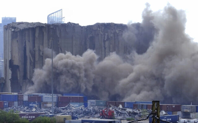 Dust is seen rising from the grain silos in the port of Beirut after a portion of them collapsed after a fire on July 31, 2022. (AP Photo) Dust is seen rising from the grain silos in the port of Beirut after a portion of them collapsed after a fire on July 31, 2022. (AP Photo)