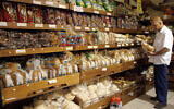 Illustrative: A man shops for bread in a supermarket in Jerusalem. (Orel Cohen/Flash90)