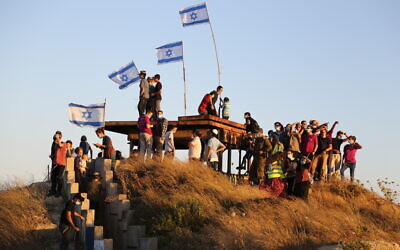 Settler activists take part in a protest march against then-US president Donald Trump's 'Deal of the Century' and an attempt to establish a new settlement called 'Maalot Halhul' near Hebron, June 30, 2020. (Gershon Elinson/Flash90)