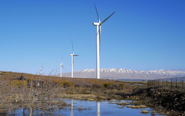 Renewable energy wind turbines as seen next to the snowy peaks of Mount Hermon on January 3, 2021, in the northern Golan Heights. (Michael Giladi/Flash90) Renewable energy wind turbines as seen next to the snowy peaks of Mount Hermon on January 3, 2021, in the northern Golan Heights. (Michael Giladi/Flash90)