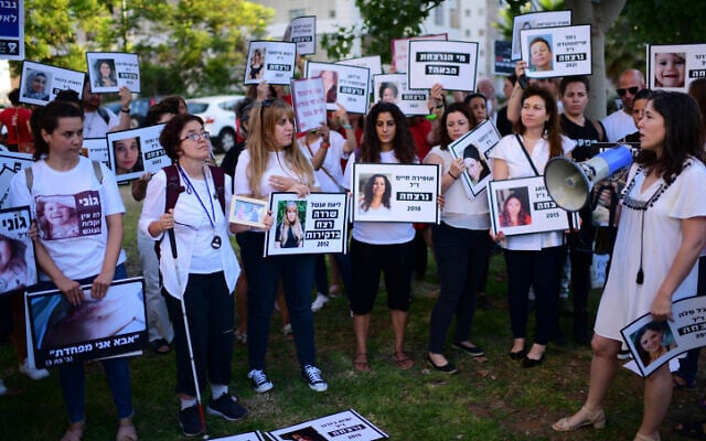 Demonstrators hold signs with images of women who have been killed as they protest against violence against women, in Tel Aviv on June 25, 2022 (Tomer Neuberg/FLASH90) Demonstrators hold signs with images of women who have been killed as they protest against violence against women, in Tel Aviv on June 25, 2022 (Tomer Neuberg/FLASH90)