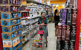 Illustrative. A grocery shopper in the northern town of Katzrin, in the Golan Heights, on July 1, 2022. (Michael Giladi/Flash90)