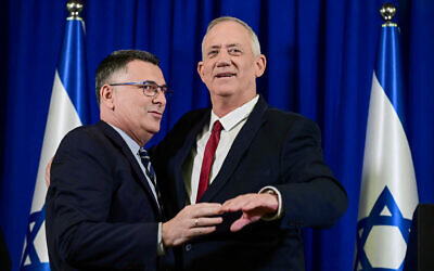 File: Blue and White leader Defense Minister Benny Gantz (right) and New Hope leader Justice Minister Gideon Sa'ar announce a merger of their parties, July 10, 2022. (Tomer Neuberg/Flash90)