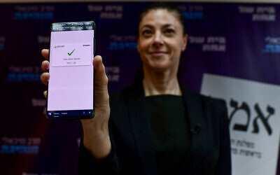 Labor leader and Transportation Minister Merav Michaeli votes via phone in Labor's leadership primaries, at primary headquarters in Tel Aviv, July 18, 2022. (Tomer Neuberg/Flash90)