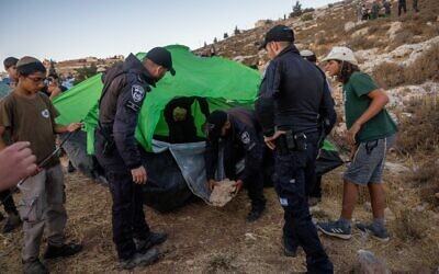 Settlers set up tents in an effort to establish a new illegal outpost near Kiryat Arba, July 20, 2022. (Yonatan Sindel/FLASH90)