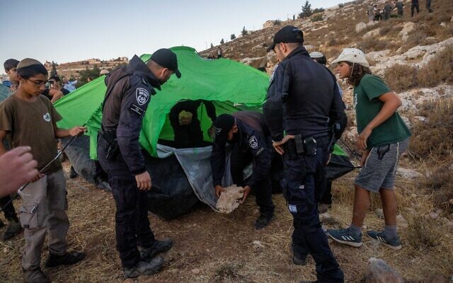 Settlers set up tents in an effort to establish a new illegal outpost near Kiryat Arba, July 20, 2022. (Yonatan Sindel/FLASH90) Settlers set up tents in an effort to establish a new illegal outpost near Kiryat Arba, July 20, 2022. (Yonatan Sindel/FLASH90)