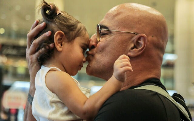 Dudi Ashkenazi, right, who was arrested and held for weeks in Greece, is welcomed by family and friends as he arrives at the Ben Gurion International Airport, outside of Tel Aviv, on July 30, 2022. (Gideon Markowicz/Flash90) Dudi Ashkenazi, right, who was arrested and held for weeks in Greece, is welcomed by family and friends as he arrives at the Ben Gurion International Airport, outside of Tel Aviv, on July 30, 2022. (Gideon Markowicz/Flash90)