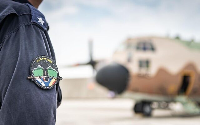 An Israeli Air Force pilot is seen next to a C-130 transport aircraft in Romania, July 4, 2022. (Israel Defense Forces) An Israeli Air Force pilot is seen next to a C-130 transport aircraft in Romania, July 4, 2022. (Israel Defense Forces)