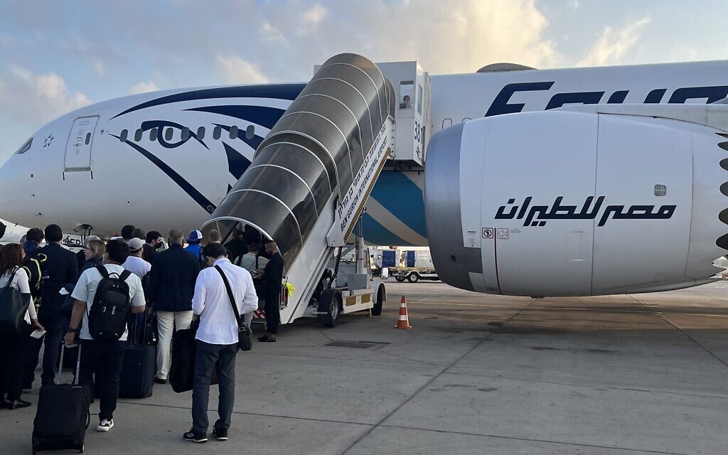 The White House press corps boards a chartered Egypt Air plane for Jeddah at Ben Gurion Airport on July 15, 2022. (Jacob Magid/Times of Israel)