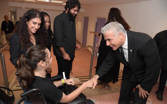 Prime Minister Yair Lapid attends a conference to present the new Social Services Law for People with Disabilities on July 25, 2022. (Haim Zach /GPO)