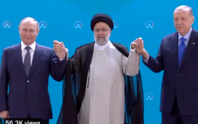 Russian President Vladimir Putin, Iran President Ebrahim Raisi and Turkish President Recep Tayyip Erdogan hold hands during a trilateral summit in Tehran on July 19, 2022. (Screen capture/Twitter) Russian President Vladimir Putin, Iran President Ebrahim Raisi and Turkish President Recep Tayyip Erdogan hold hands during a trilateral summit in Tehran on July 19, 2022. (Screen capture/Twitter)