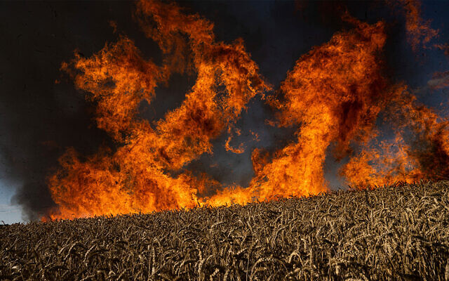 A wheat field burns after Russian shelling a few kilometres from the Ukrainian-Russian border in the Kharkiv region, Ukraine, July 29, 2022. (AP Photo/Evgeniy Maloletka) A wheat field burns after Russian shelling a few kilometres from the Ukrainian-Russian border in the Kharkiv region, Ukraine, July 29, 2022. (AP Photo/Evgeniy Maloletka)