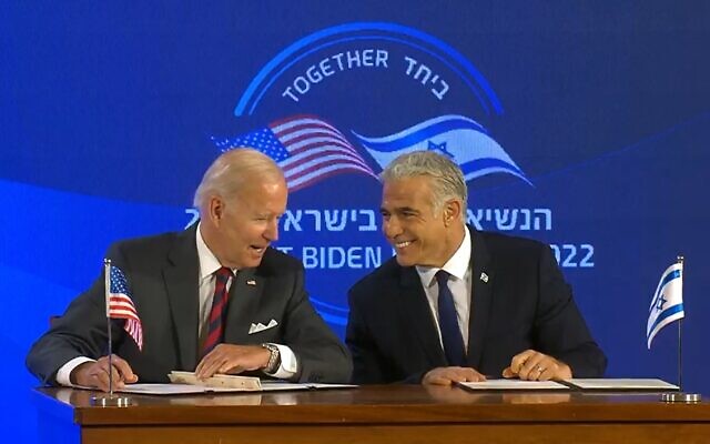 US President Joe Biden (left) and Prime Minister Yair Lapid sign the Jerusalem Declaration at the Waldorf Astoria Hotel in Jerusalem, July 14, 2022. (Screenshot) US President Joe Biden (left) and Prime Minister Yair Lapid sign the Jerusalem Declaration at the Waldorf Astoria Hotel in Jerusalem, July 14, 2022. (Screenshot)